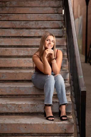 Senior girl pose while sitting on stairs