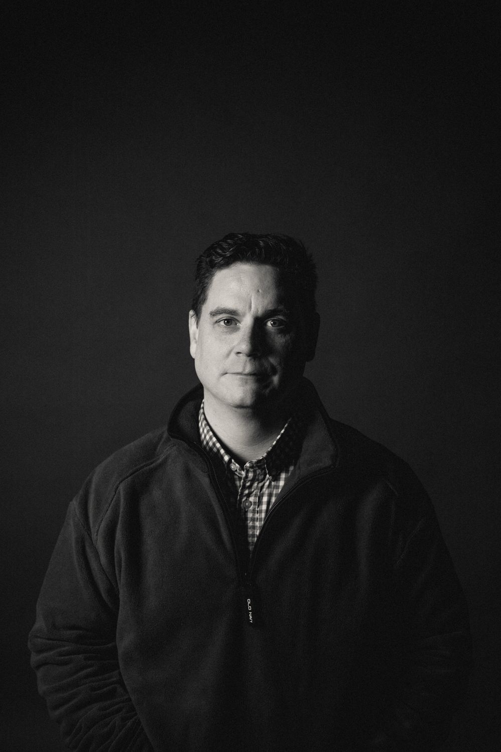 Black And White headshot photography in a studio setting staring at camera.
