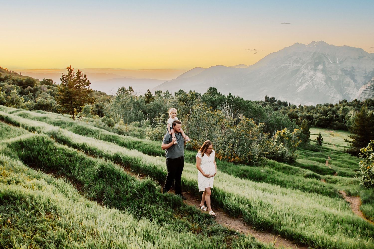 Maternity family session up Provo Canyon, Utah with beautiful sunset behind them