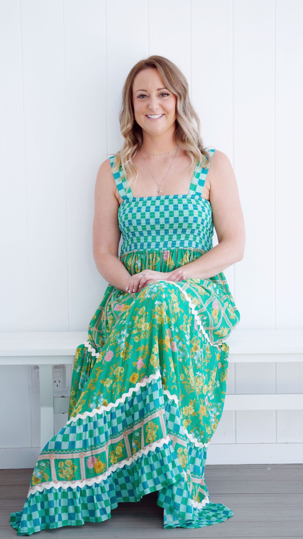 Summery teal and green patterned maxi dress photographed against white backdrop.