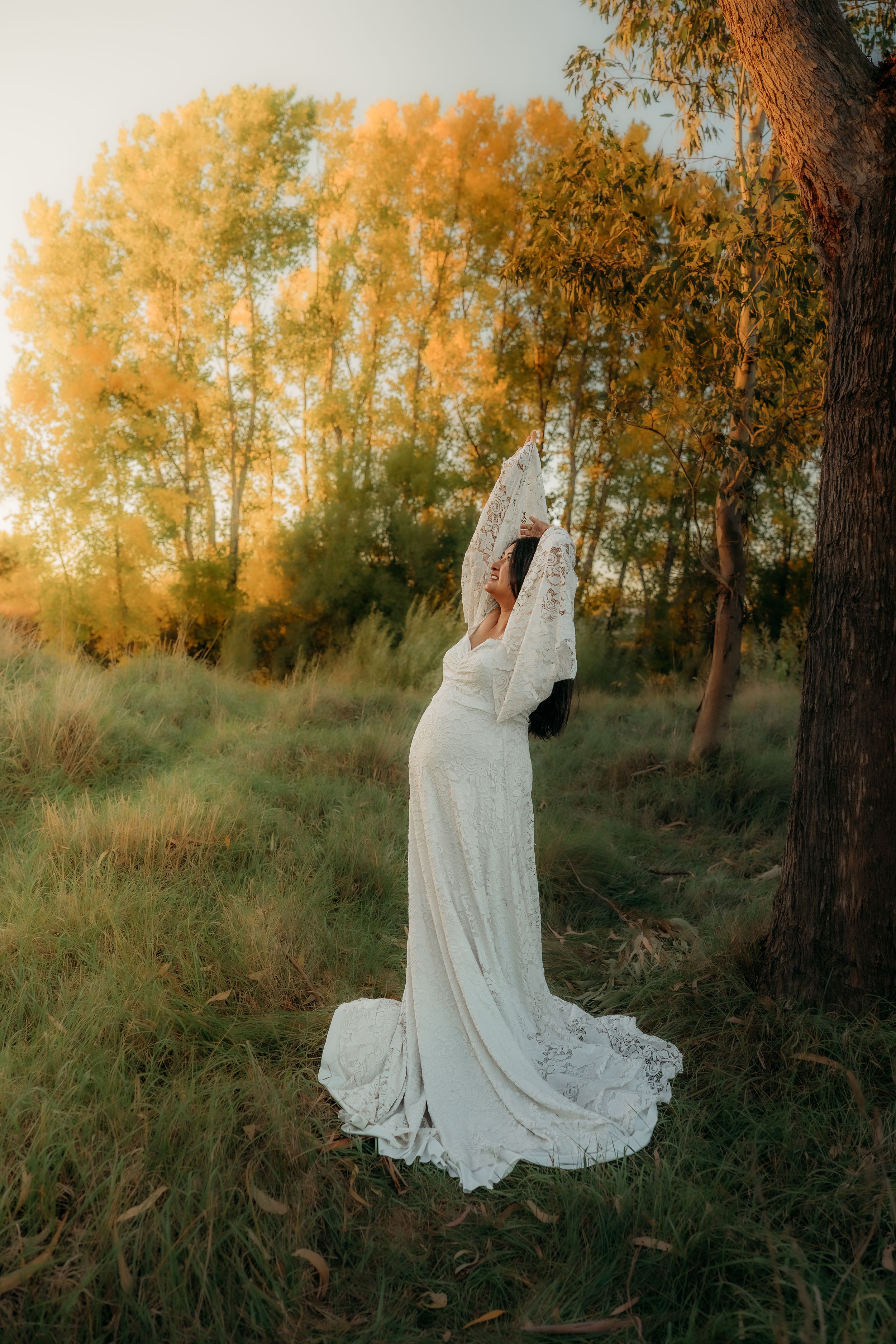 Maternity photography session golden autumn trees at sunset.