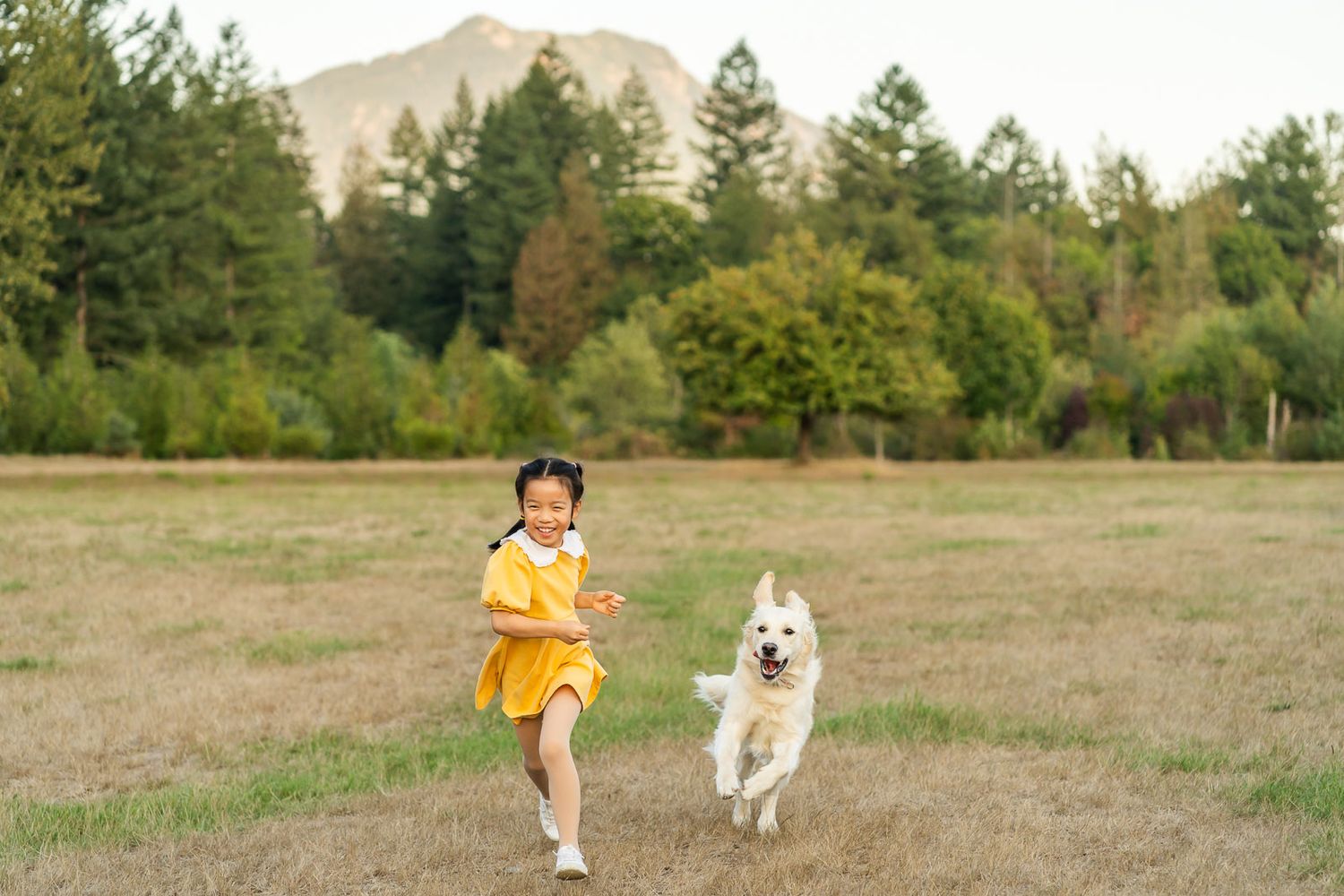 Girl running with her dog at Tanner Landing Park.