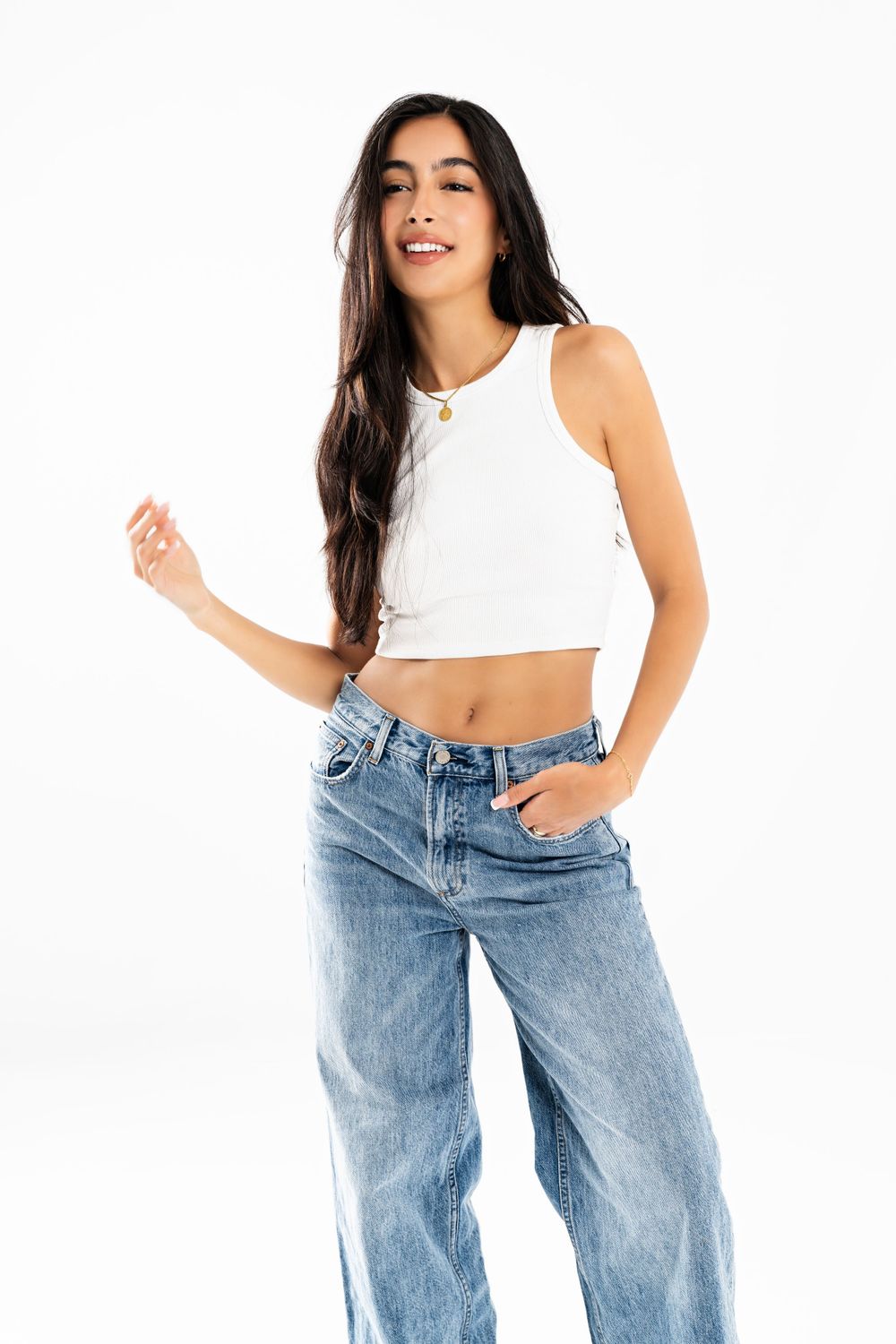 Lifestyle fashion shoot featuring casual denim and white crop top outfit.