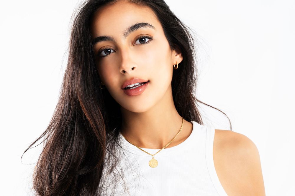 Portrait style fashion photography with natural makeup and casual styling.