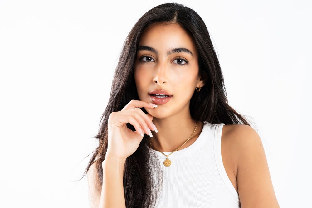 Close-up fashion portrait showcasing natural beauty and casual style.