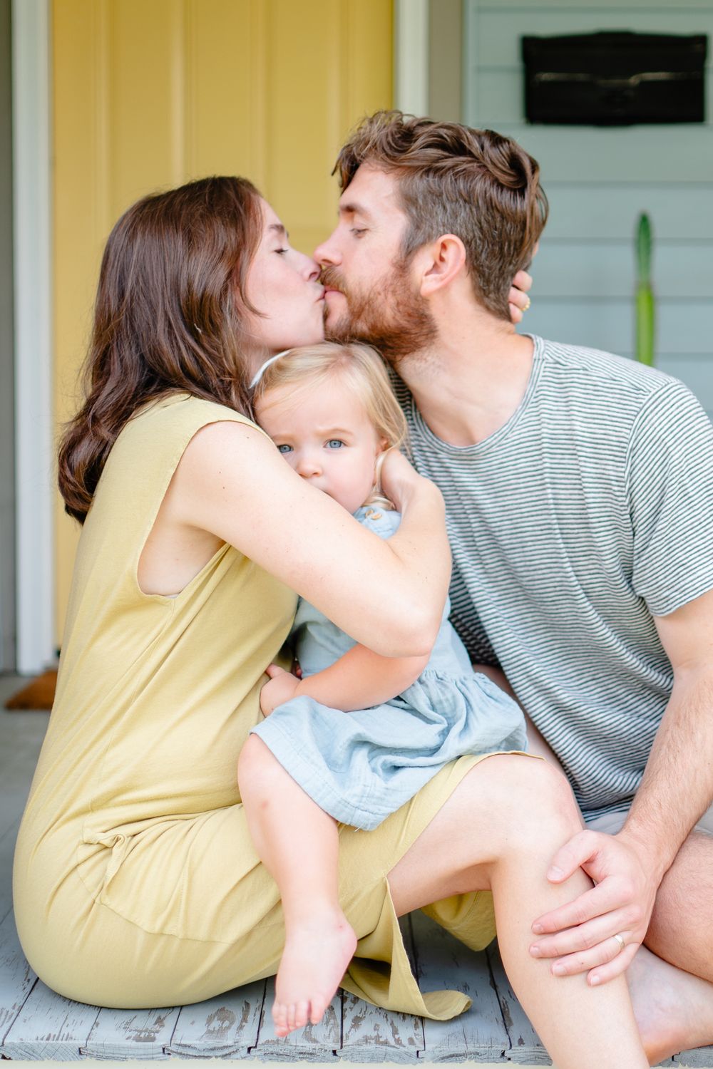Little girl snuggles close to mom during Winston-Salem maternity photos.