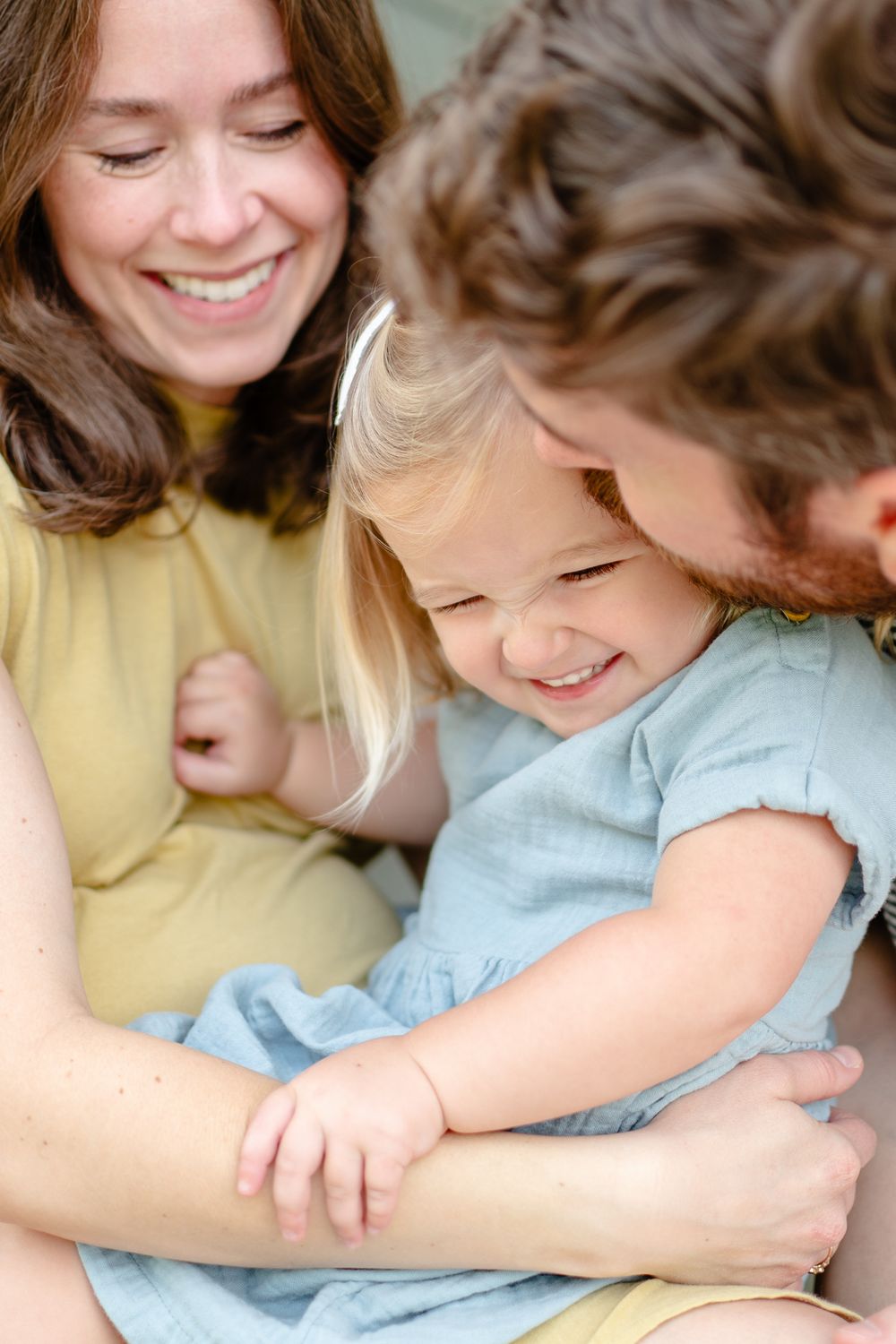 At-home family sessions allow for lots of natural interaction like this moment between dad and daughter.