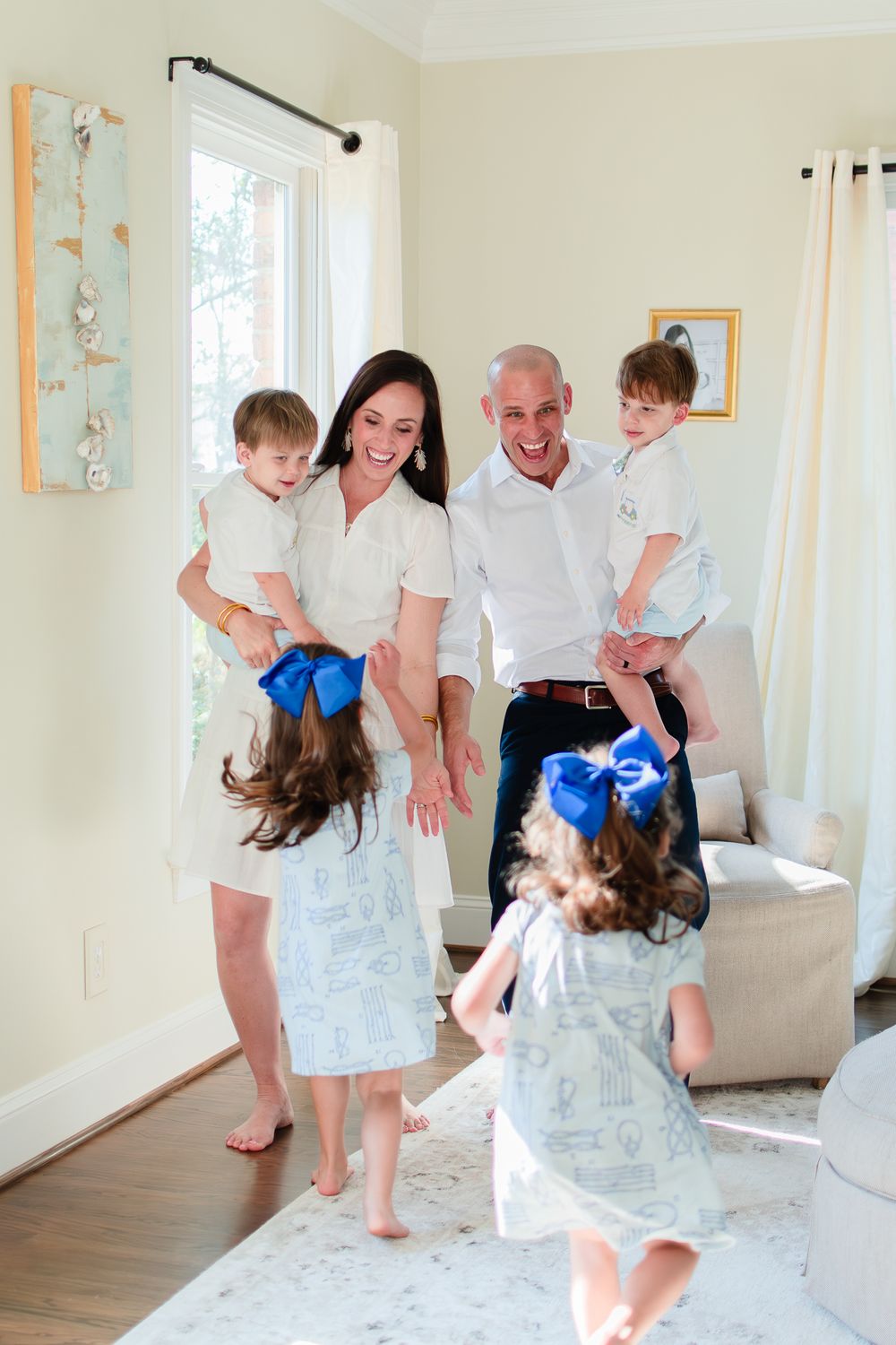 Family of four kids laugh and play during their at-home family photo session.