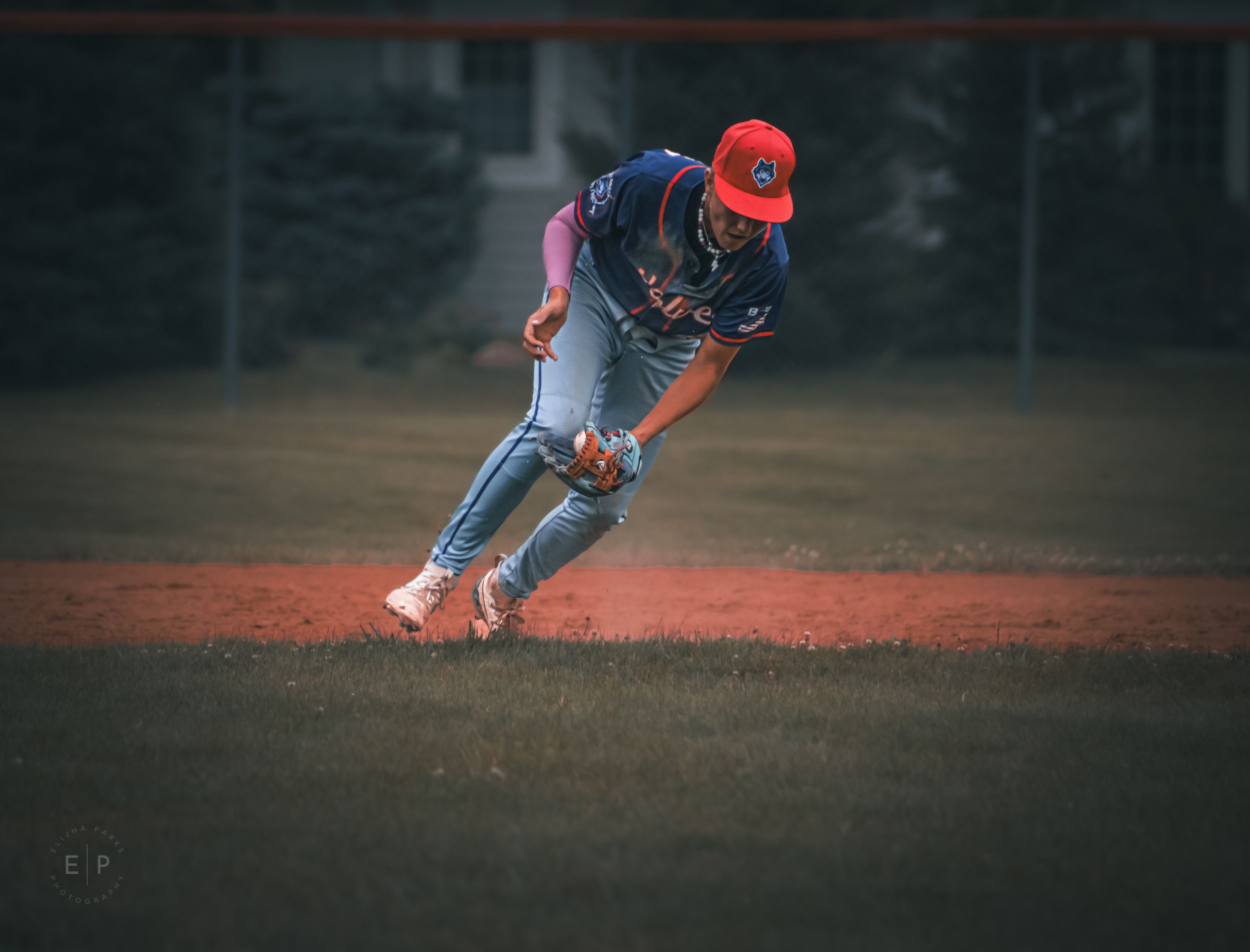 Baseball player fielding ball in uniform