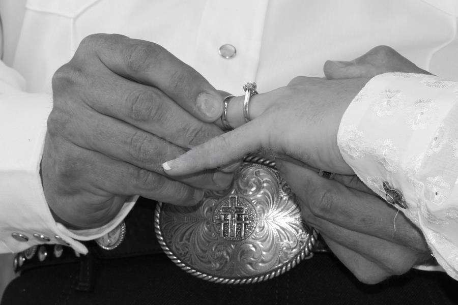 Black and white close-up of hands placing a ring during a wedding ceremony.
Wedding photography