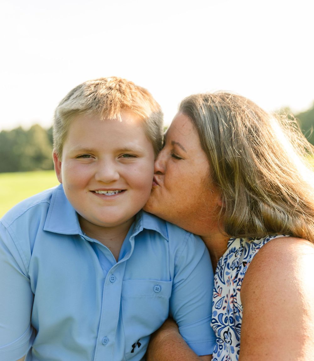A sweet candid moment of affection captured in golden evening light.