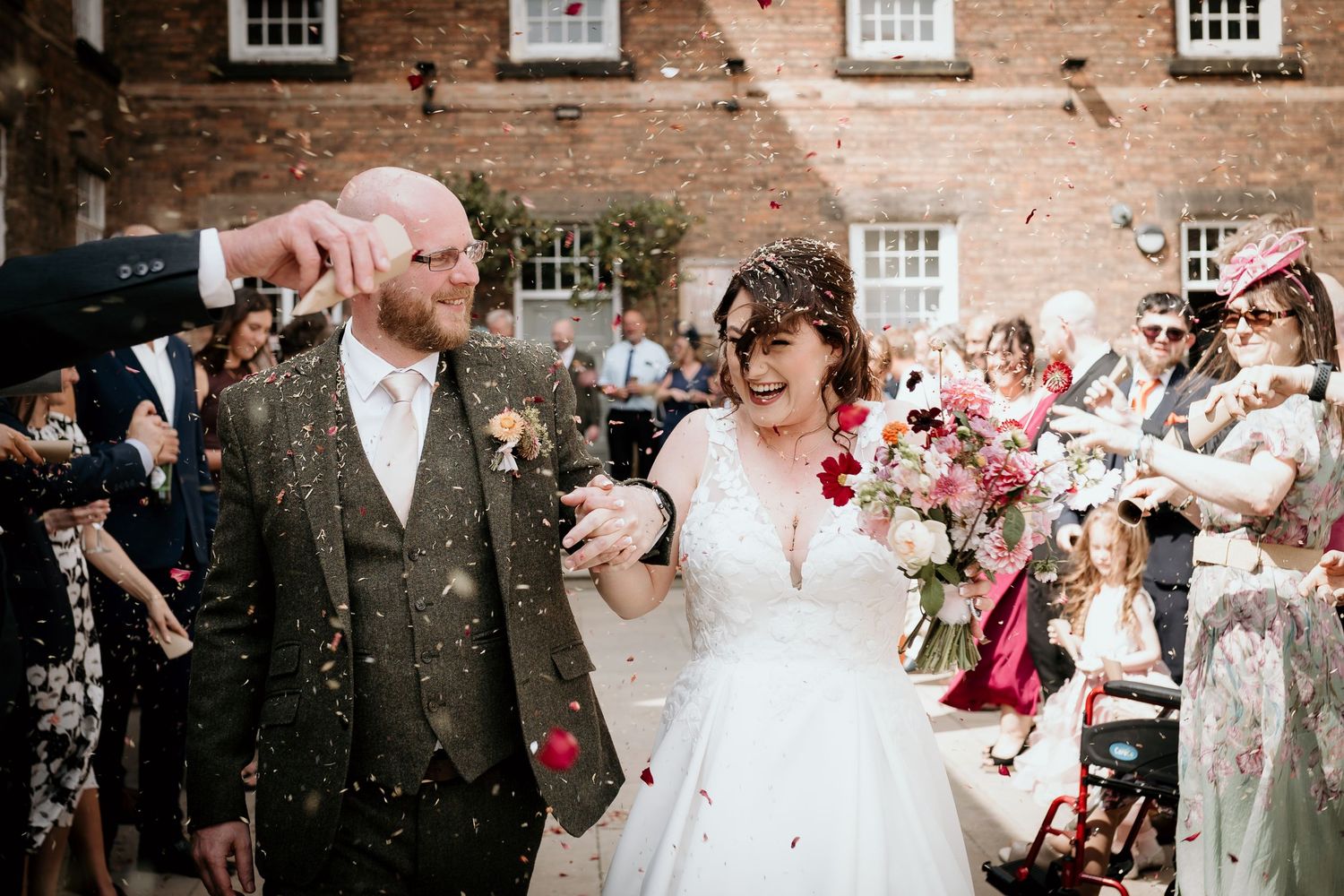 bride and groom confetti in Idyllic courtyard at The West Mill Derbyshire wedding venue