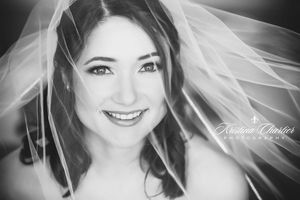 Black and white bridal portrait through delicate veil.
