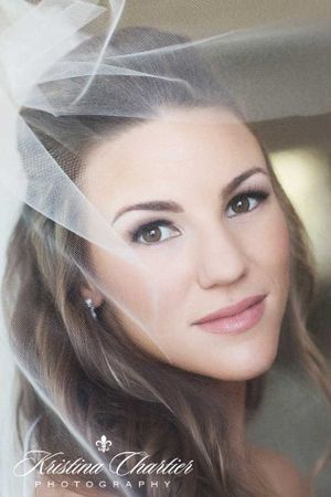 Close up portrait of a bride wearing a delicate tulle veil.