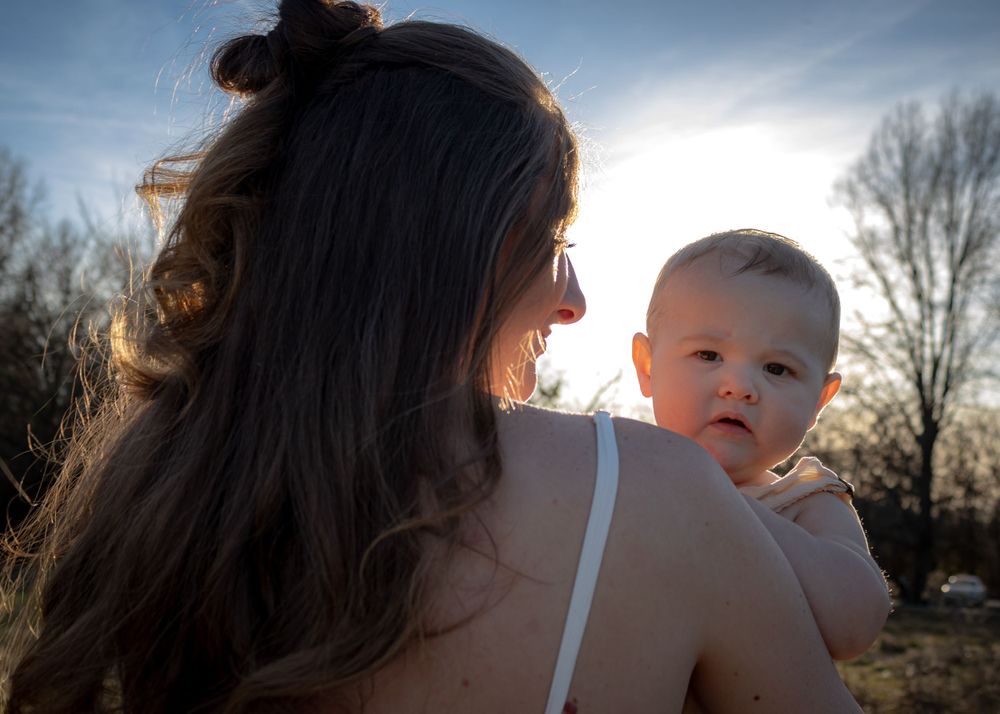 Baby looking over moms shoulder