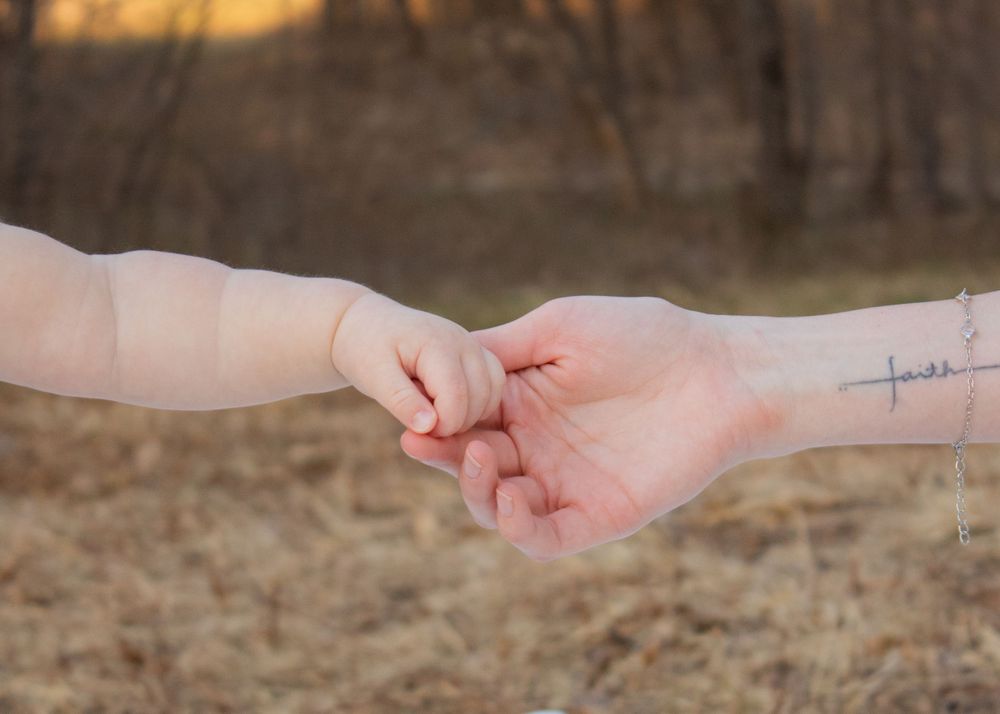 mom and baby outstretched hands