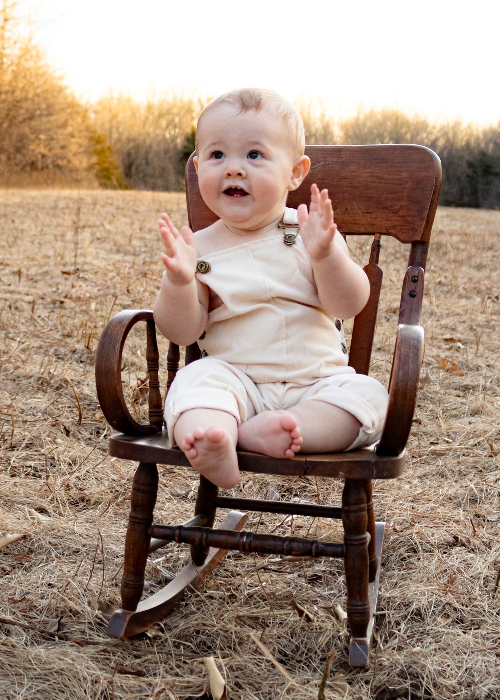 baby clapping in rocking chair