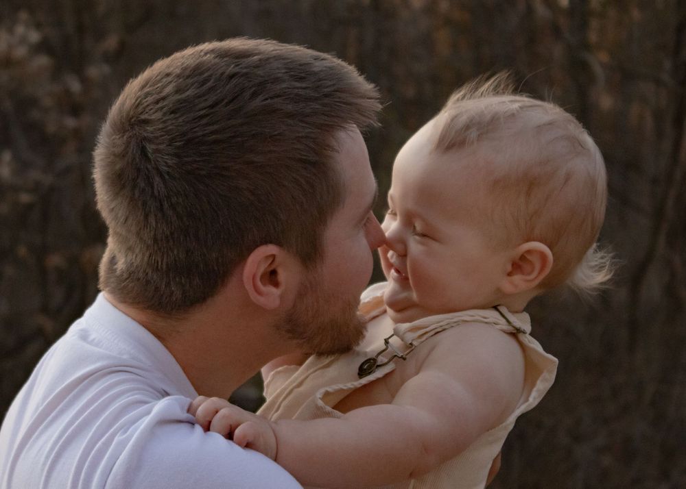 dad and baby touching noses