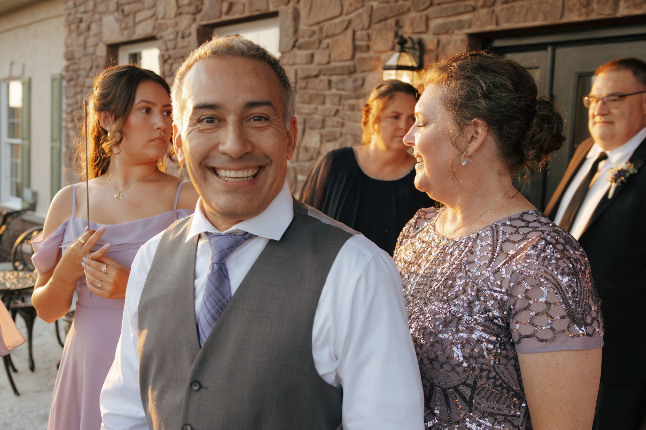 Wedding reception guests celebrating and socializing at an elegant venue during a joyous gathering.