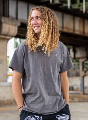 Casual portrait session in urban setting wearing grey t-shirt.