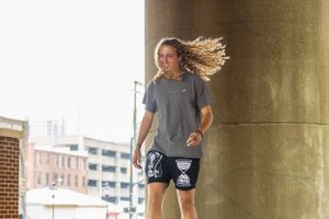 Dynamic movement shot under concrete bridge structure with natural lighting.