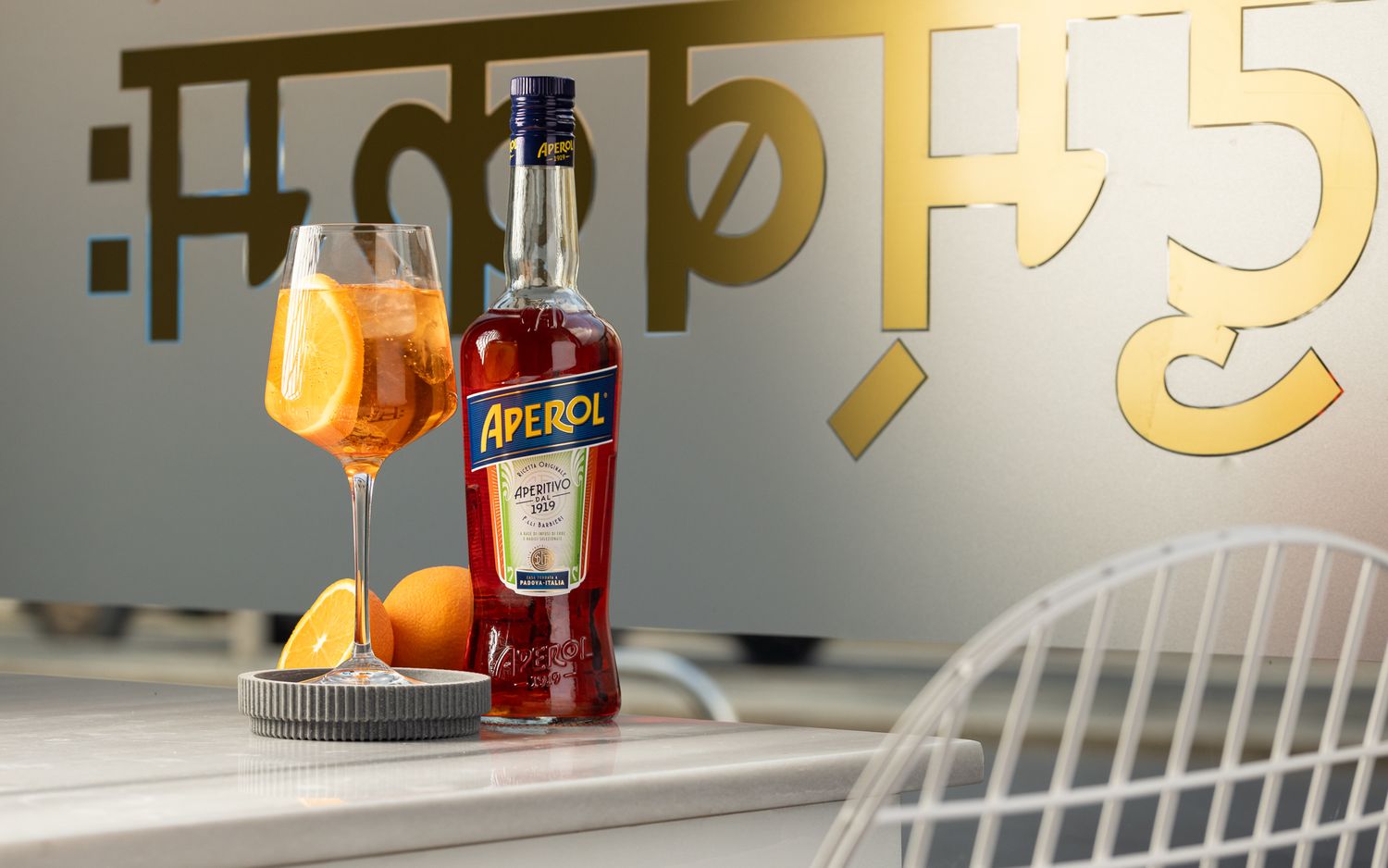 Aperol Spritz bottle and cocktail with oranges at Padharo restaurant Southampton, drinks brand product photography