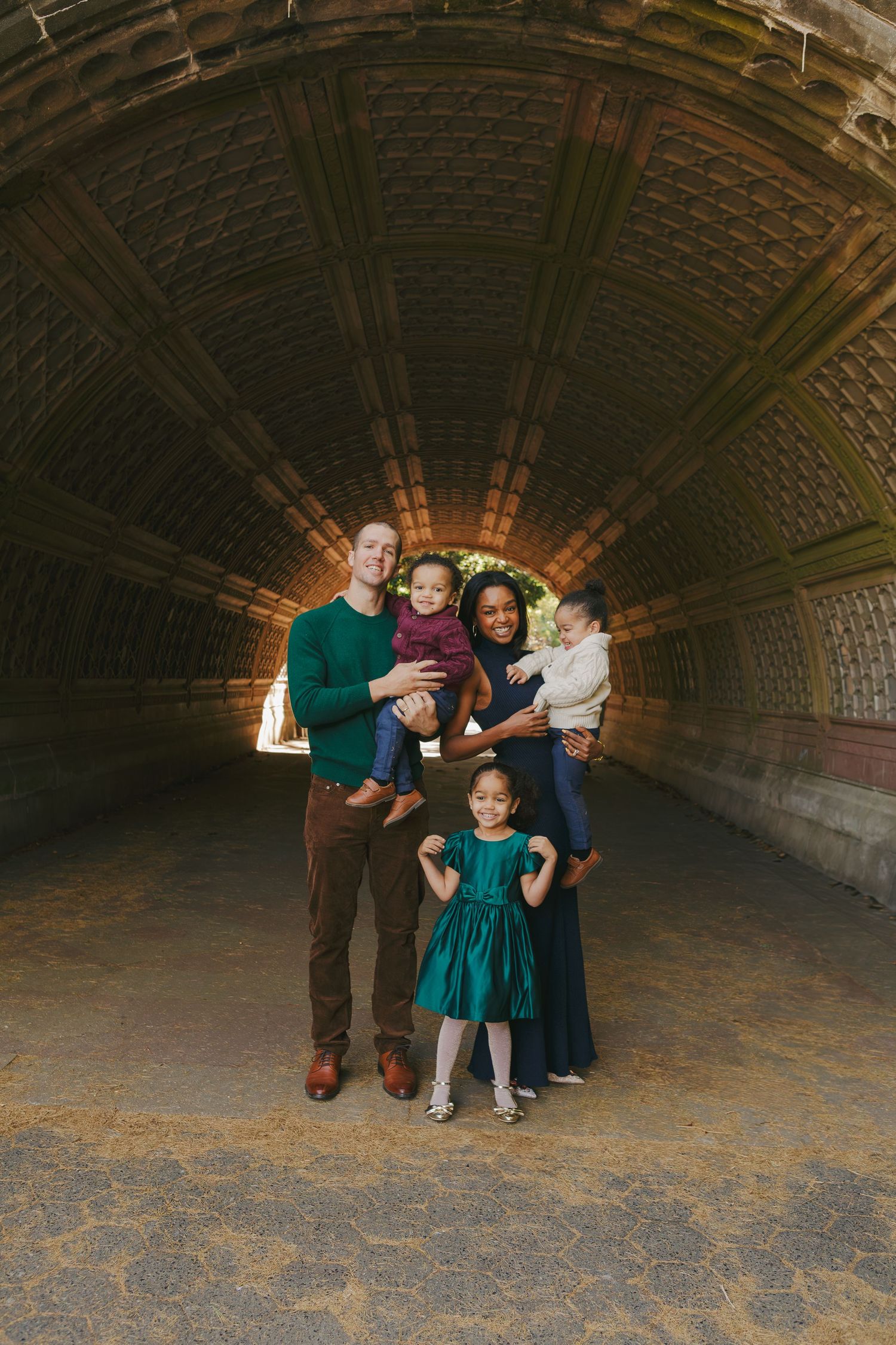 Lifestyle family portrait by Paula Brearley in NYC, featuring parents and children interacting naturally