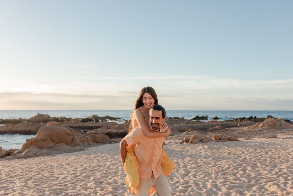 Couple walking along shoreline after ceremony