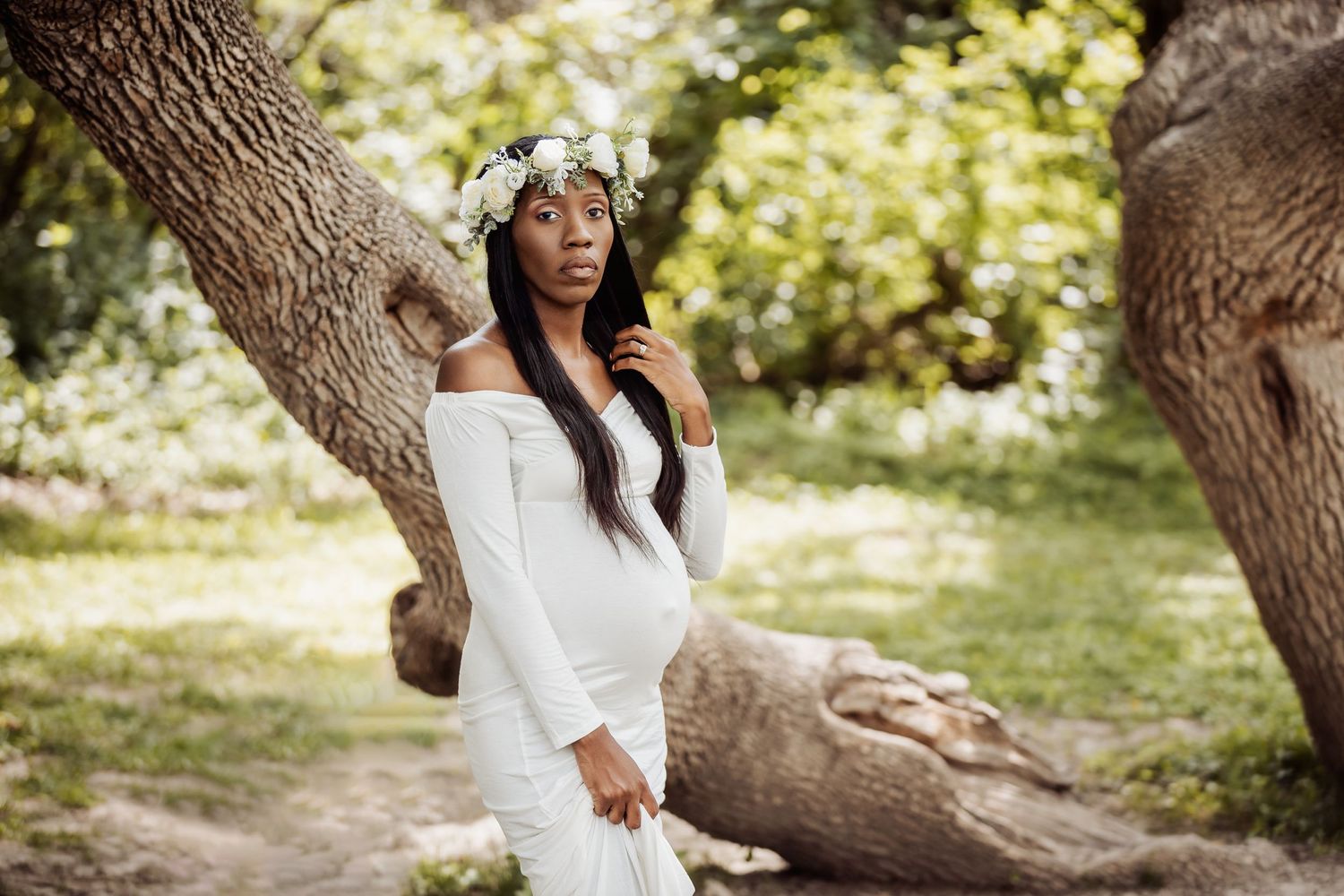 Outdoor portrait session among twisted tree branches in natural setting.