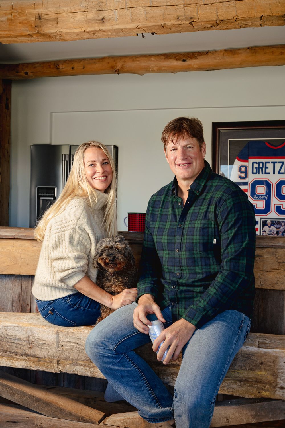 A cozy indoor scene with a dog and casual decor including a framed hockey jersey.