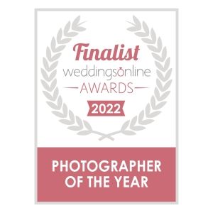 Award badge design for Weddings Online Photographer of the Year 2022 finalist in pink and gray.