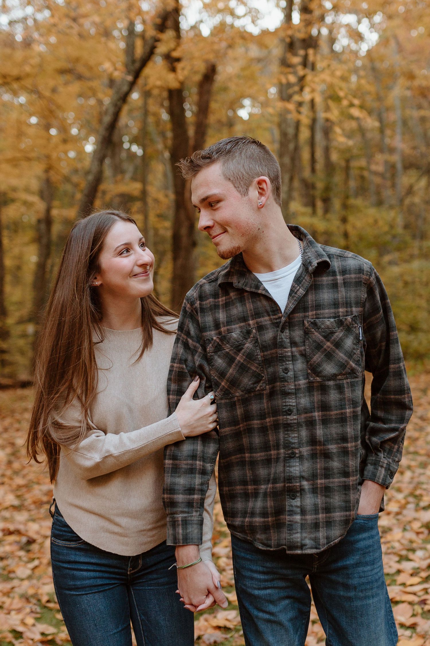 Couple holding hands as they walk and look at each other during session with Connecticut Photographer