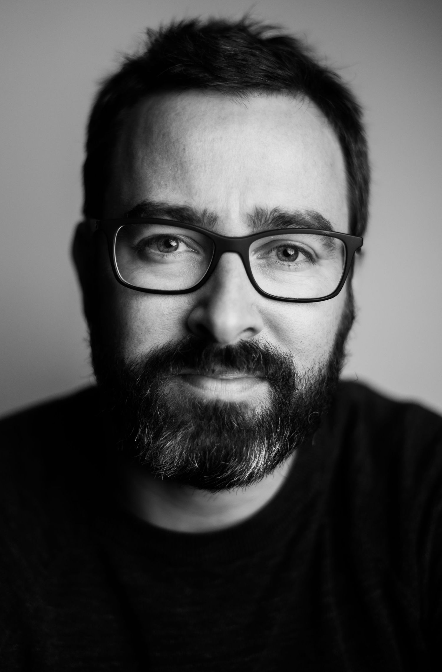 Dramatic black and white portrait series showing different expressions and angles.