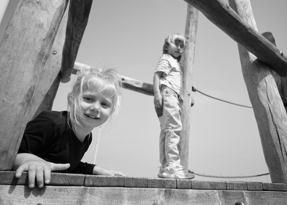 young boy and girl siblings playing in a park