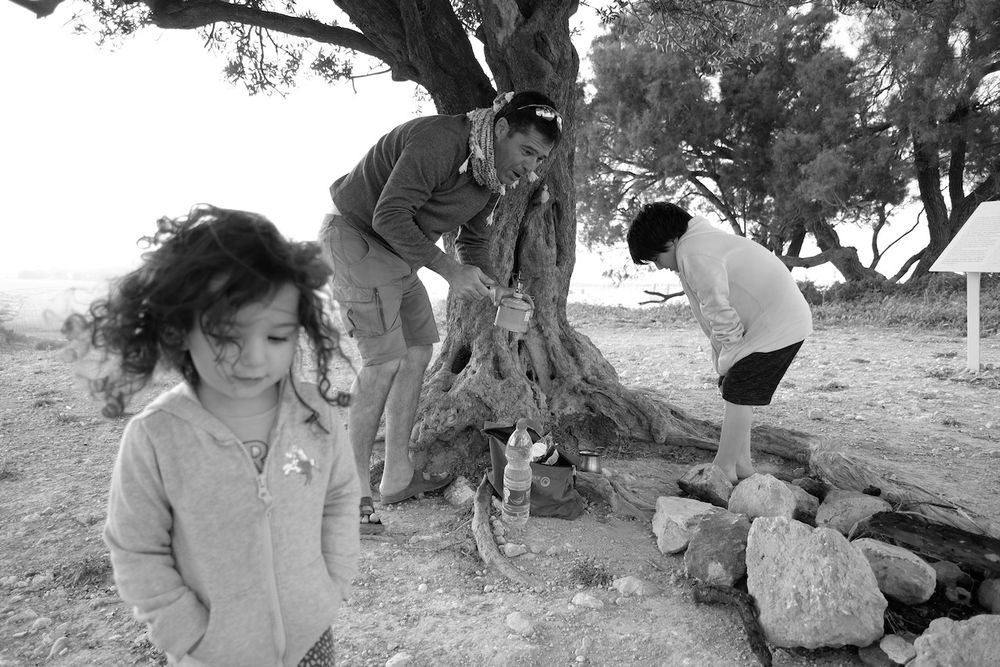 Windy outdoors family young girl walking by a tree