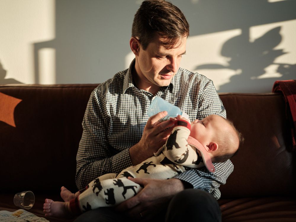 a father feeding his baby background wall with shadows
