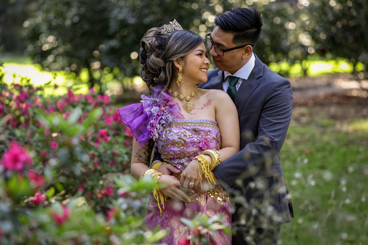 A romantic portrait in a garden with purple flowers and soft natural lighting.