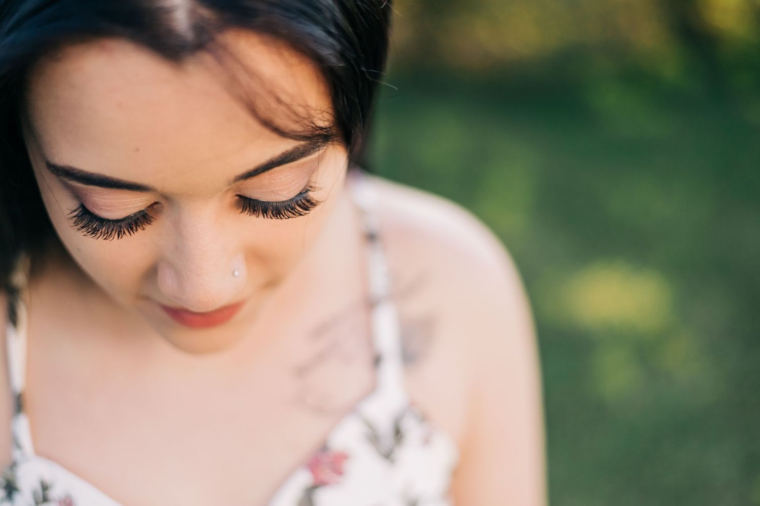 young woman looking down, photo focused on her eyelashes