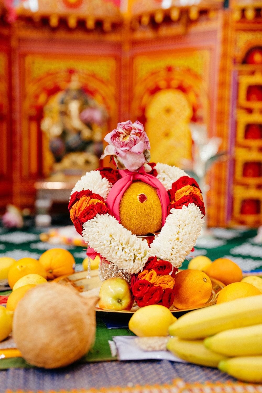 Colorful fruit offering with flowers and bananas in traditional Indian style.
