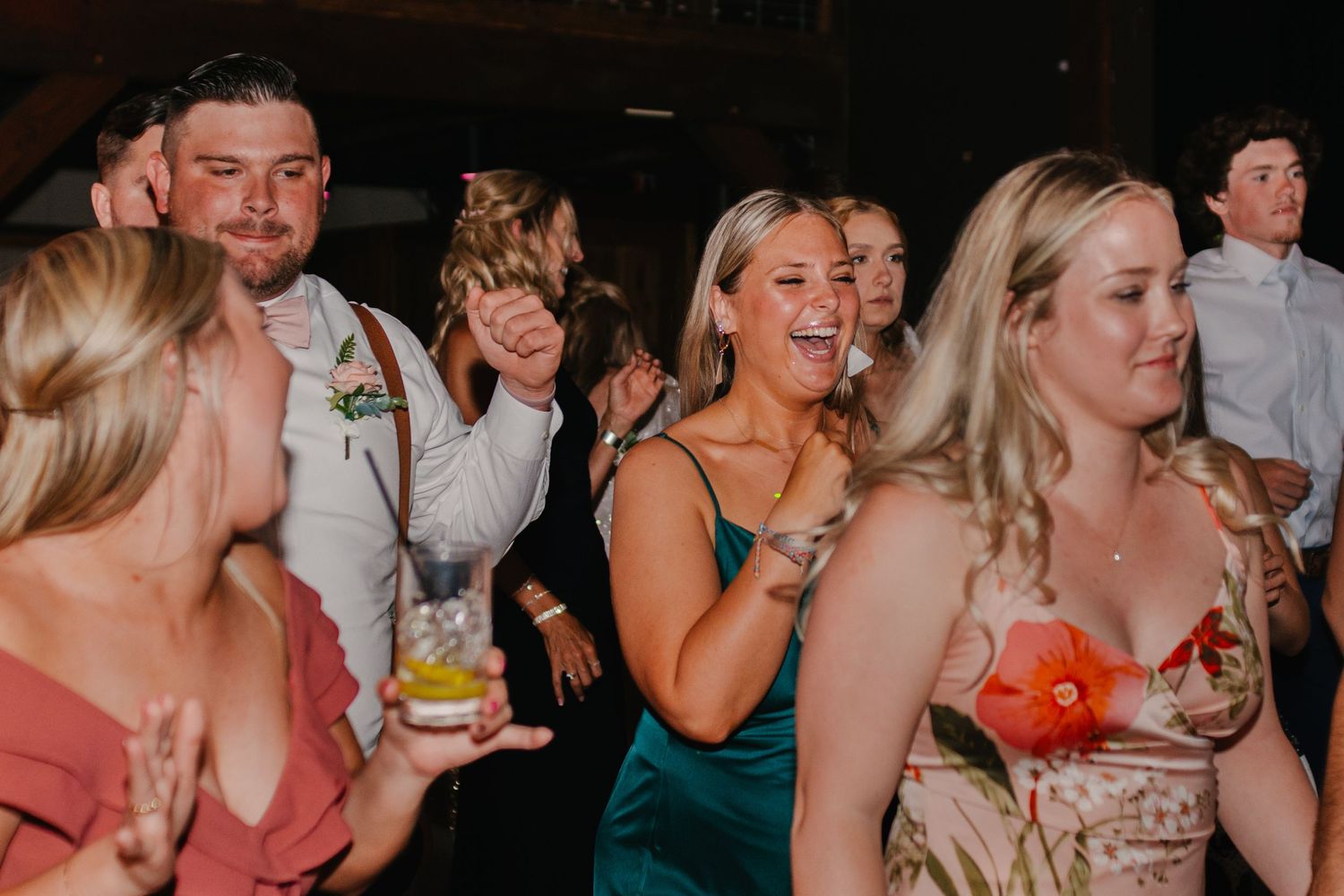 Wedding reception guests dancing and celebrating at a party.