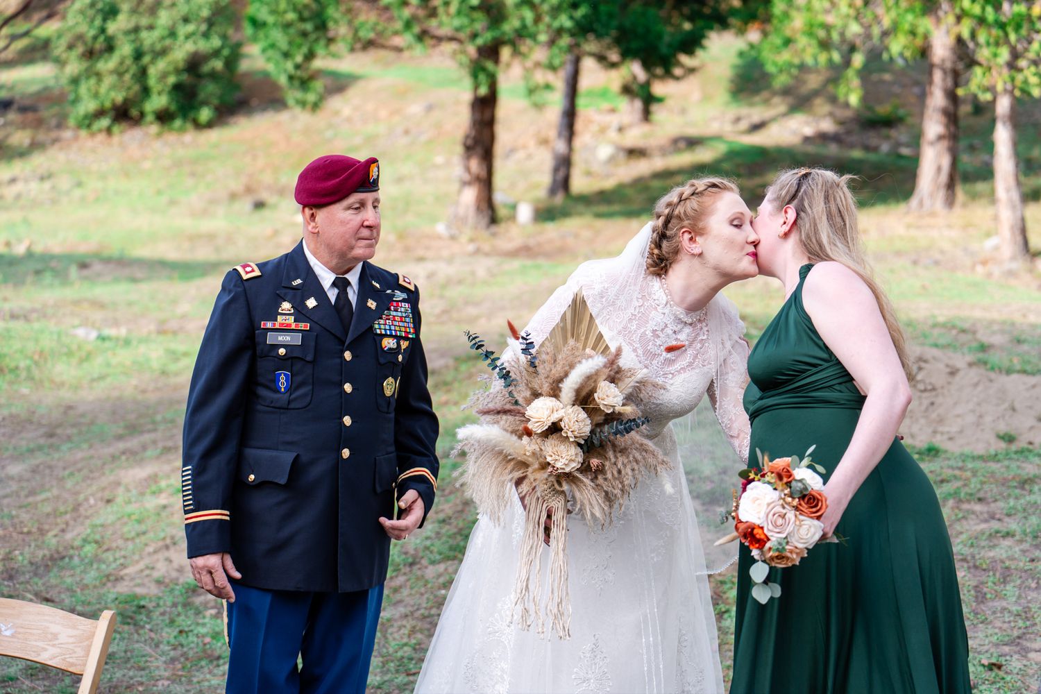 bride and maid of honor kiss