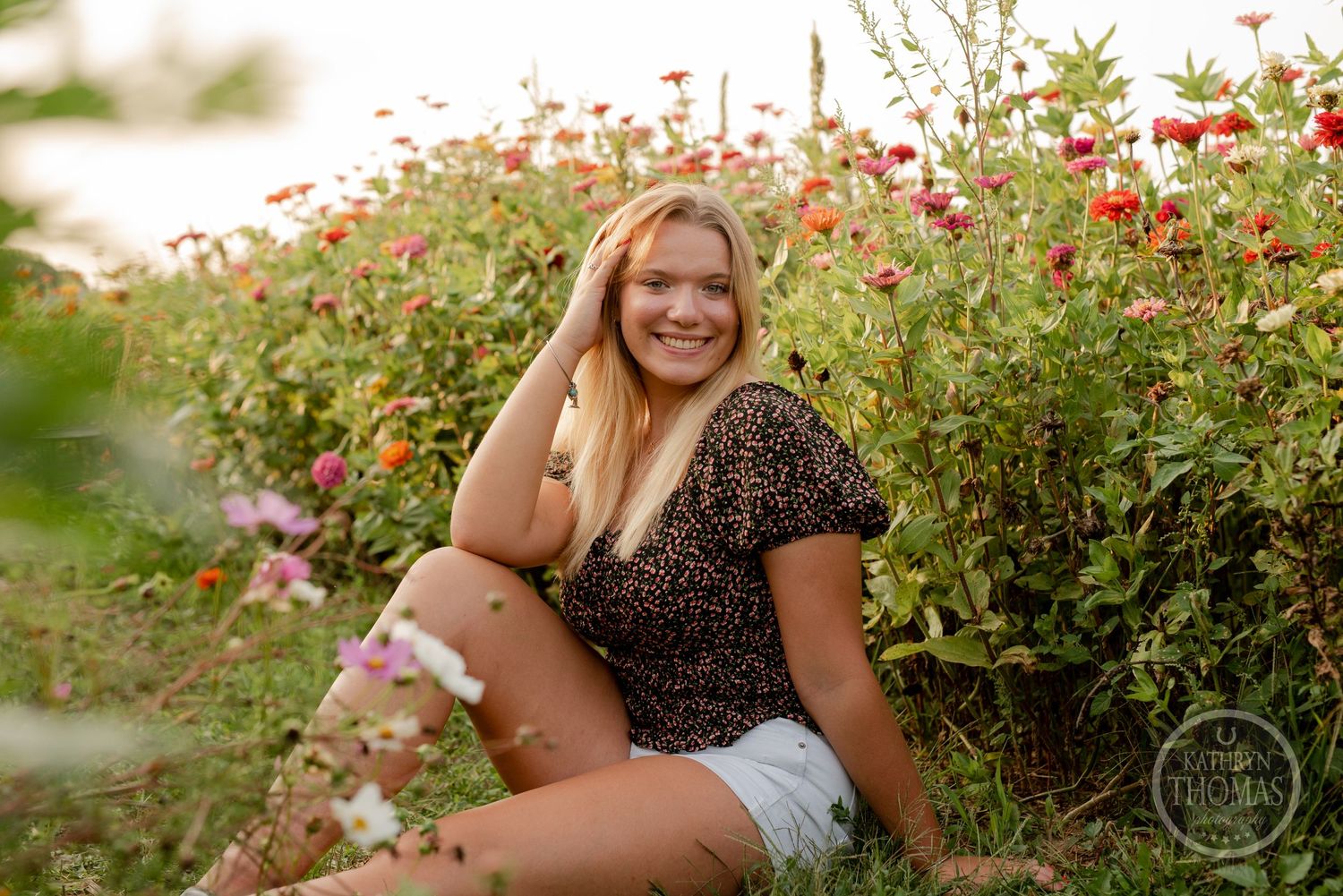 Relaxed summer portrait among red wildflowers at golden hour.