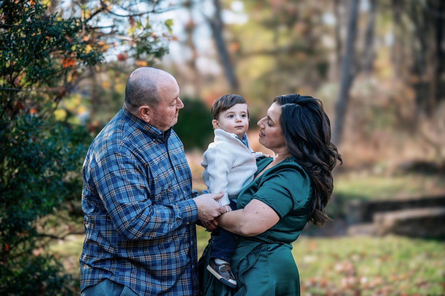 A sweet family moment captured outdoors during autumn.