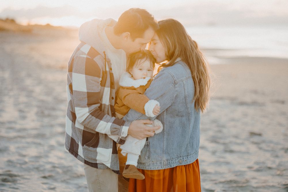 A family having a moment in Papamoa Beach for their family shoot with Apertured Media-Auckland Wedding Photographer