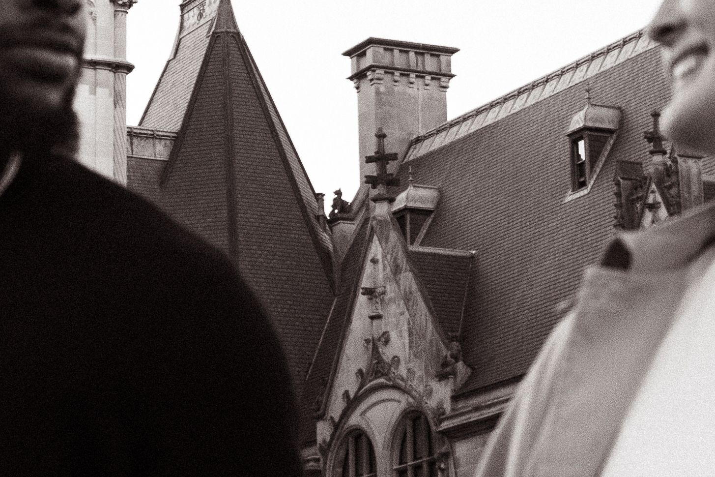 Gothic architectural details and ornate rooflines of a historic mansion captured in black and white.