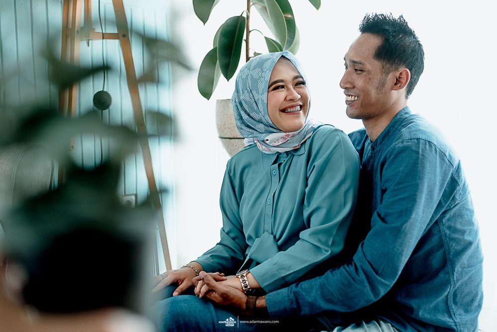 A couple shares a happy moment together by indoor plants.