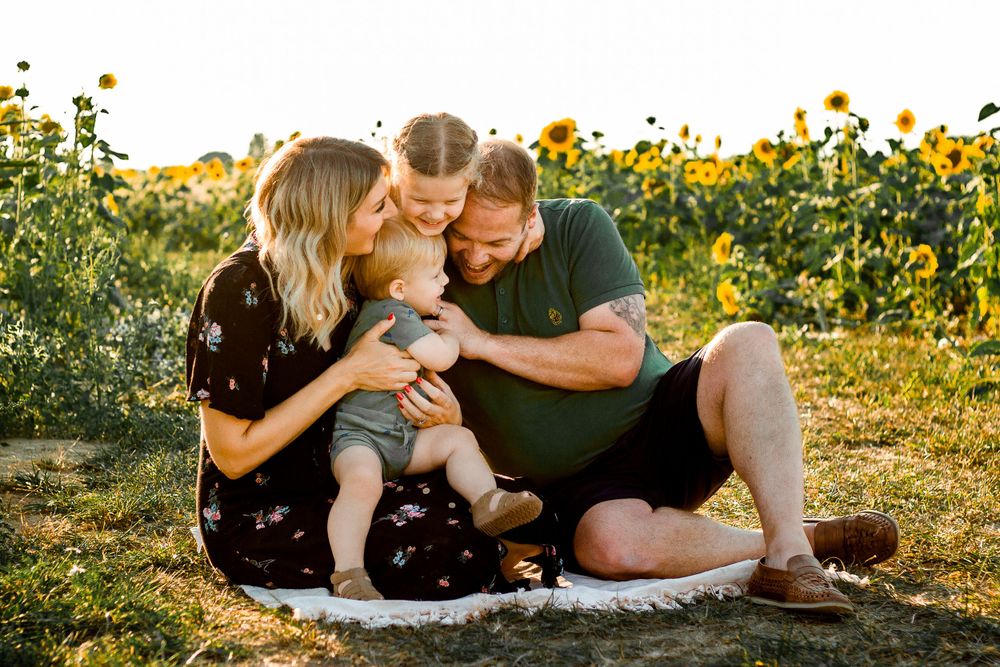 At Sam's Sunflowers on Hayling Island, Hampshire, a family laugh and play in the flowers.