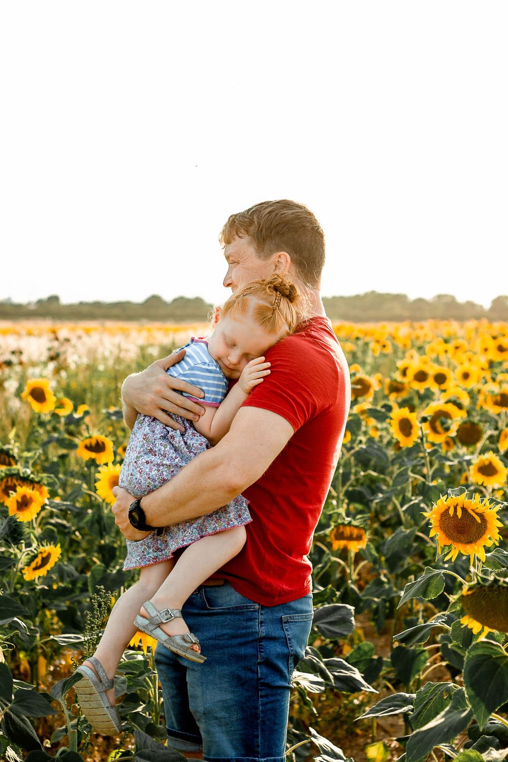 At Sam's Sunflowers on Hayling Island, Hampshire, a family laugh and play in the flowers.