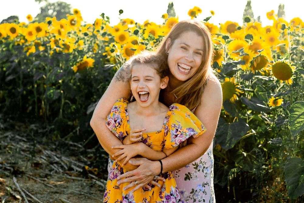 At Sam's Sunflowers on Hayling Island, Hampshire, a family laugh and play in the flowers.