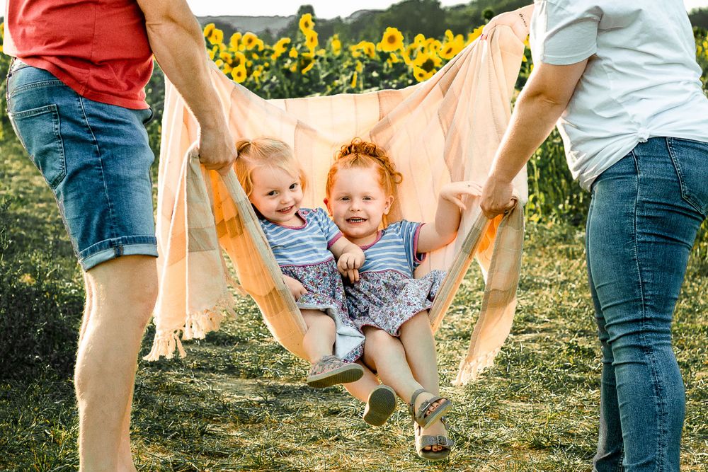 At Sam's Sunflowers on Hayling Island, Hampshire, a family laugh and play in the flowers.